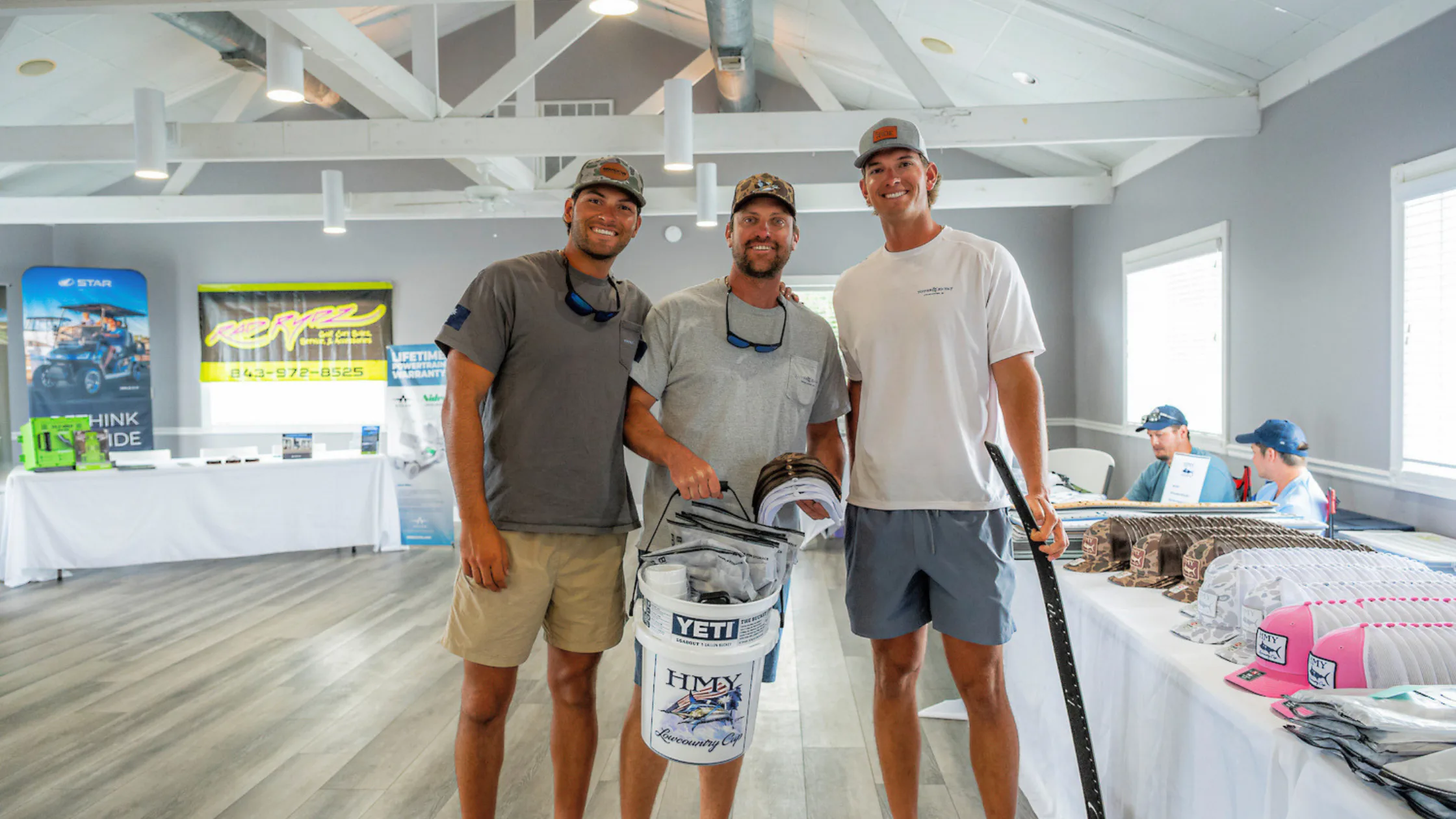 Anglers holding an HMY Lowcountry Cup YETI bucket at the tournament registration table