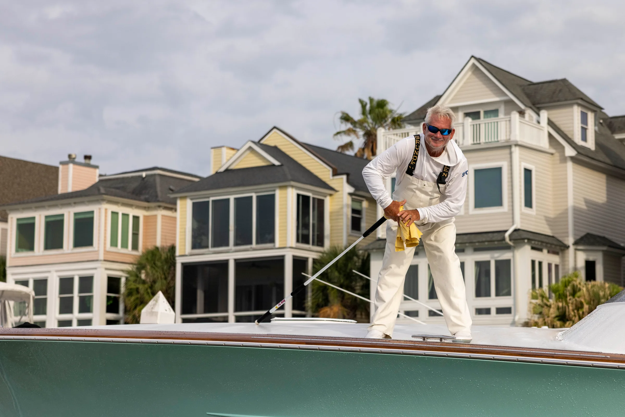 HMY
  crew member detailing the deck of a sportfishing yacht ahead of the Lowcountry Cup
