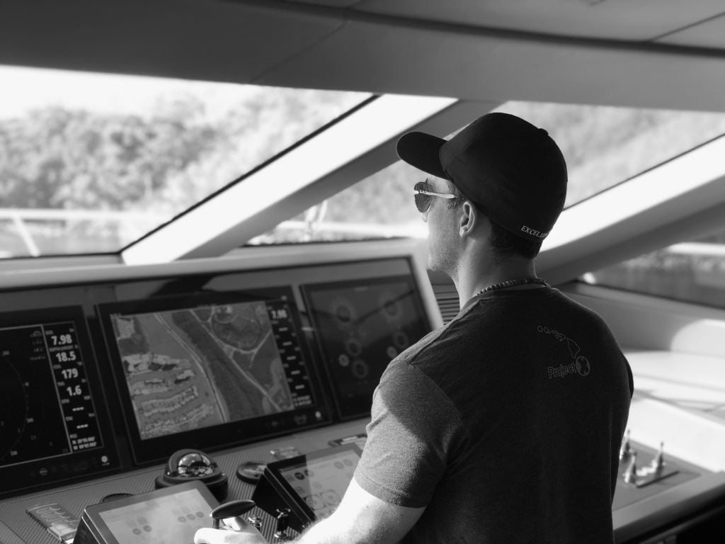 Ale Navarro at the helm of a yacht