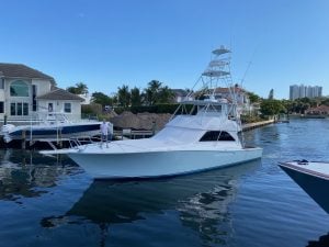 2004 Viking 56’ Convertible “Yummy Yummy” sitting in the water.