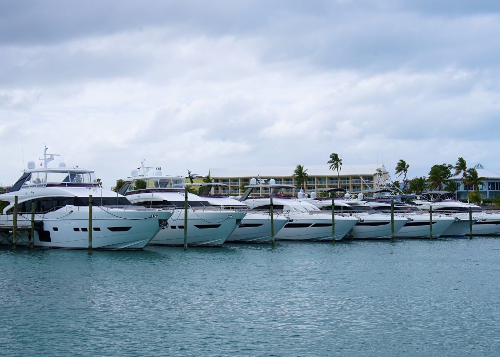 A line of Princess Yachts docked at a marina.