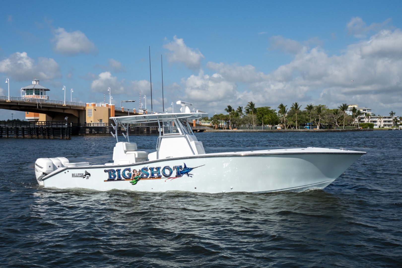 2019 Billfish 39 Center Console “Big Shot” sitting in the water next to a bridge. 