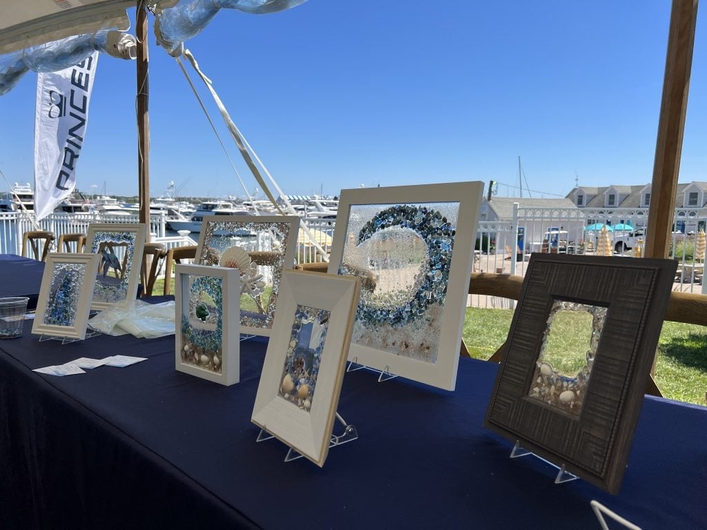Sea dhell art frames sitting on a table.