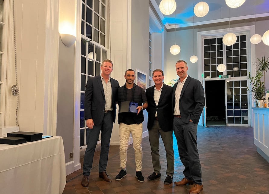 Ale Navarro and Princess Yachts America standing and holding the third place broker award.
