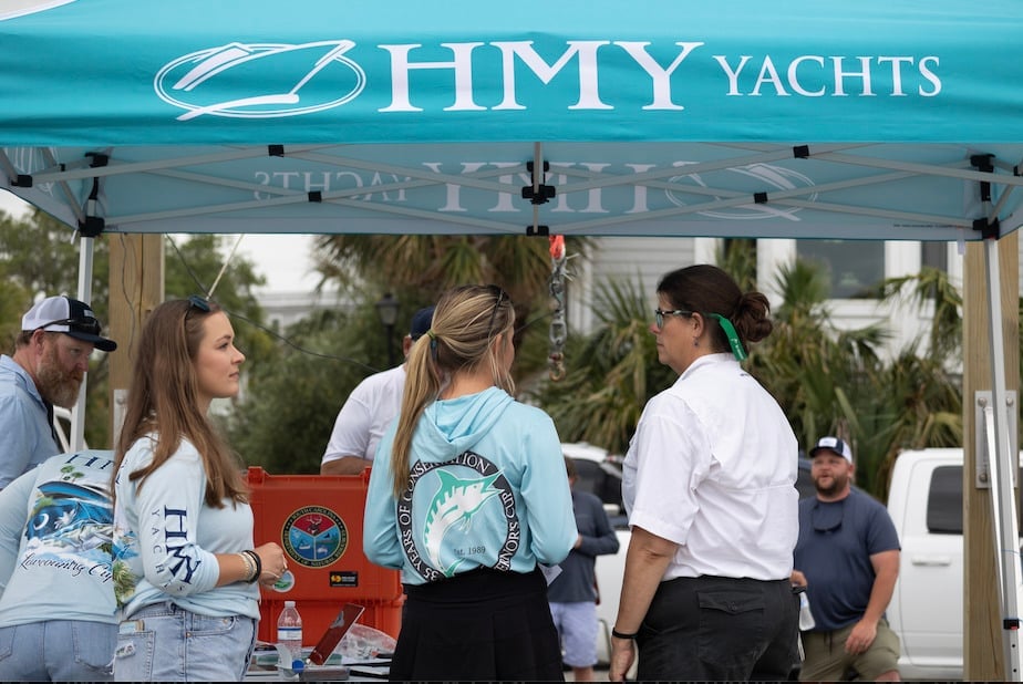 DNR and HMY Lowcountry Cup crew standing under tent at Toler's Cove Marina.
