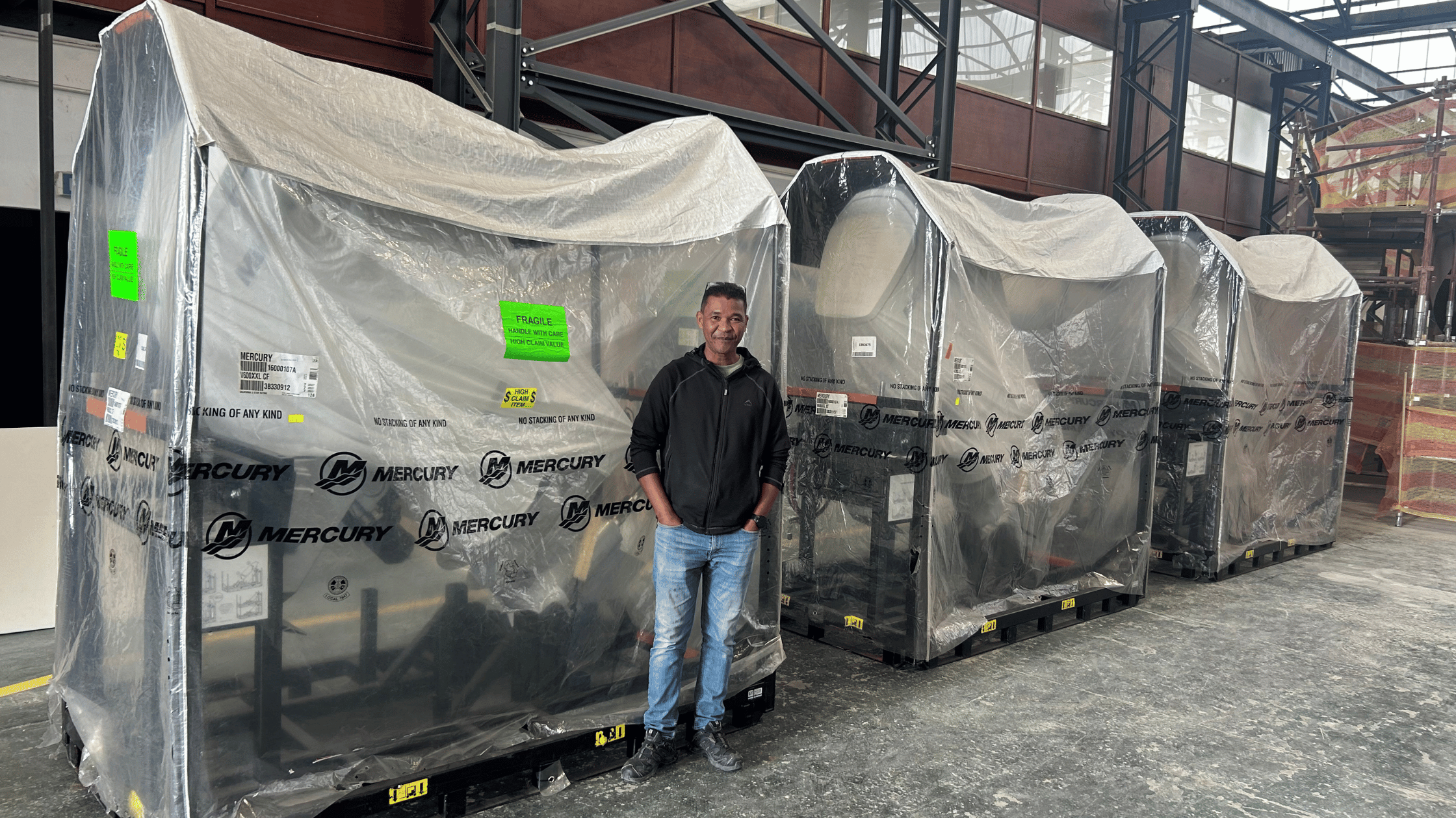 Horsepower for ECLIPSE 505. Plant manager standing next to outboard engines. 