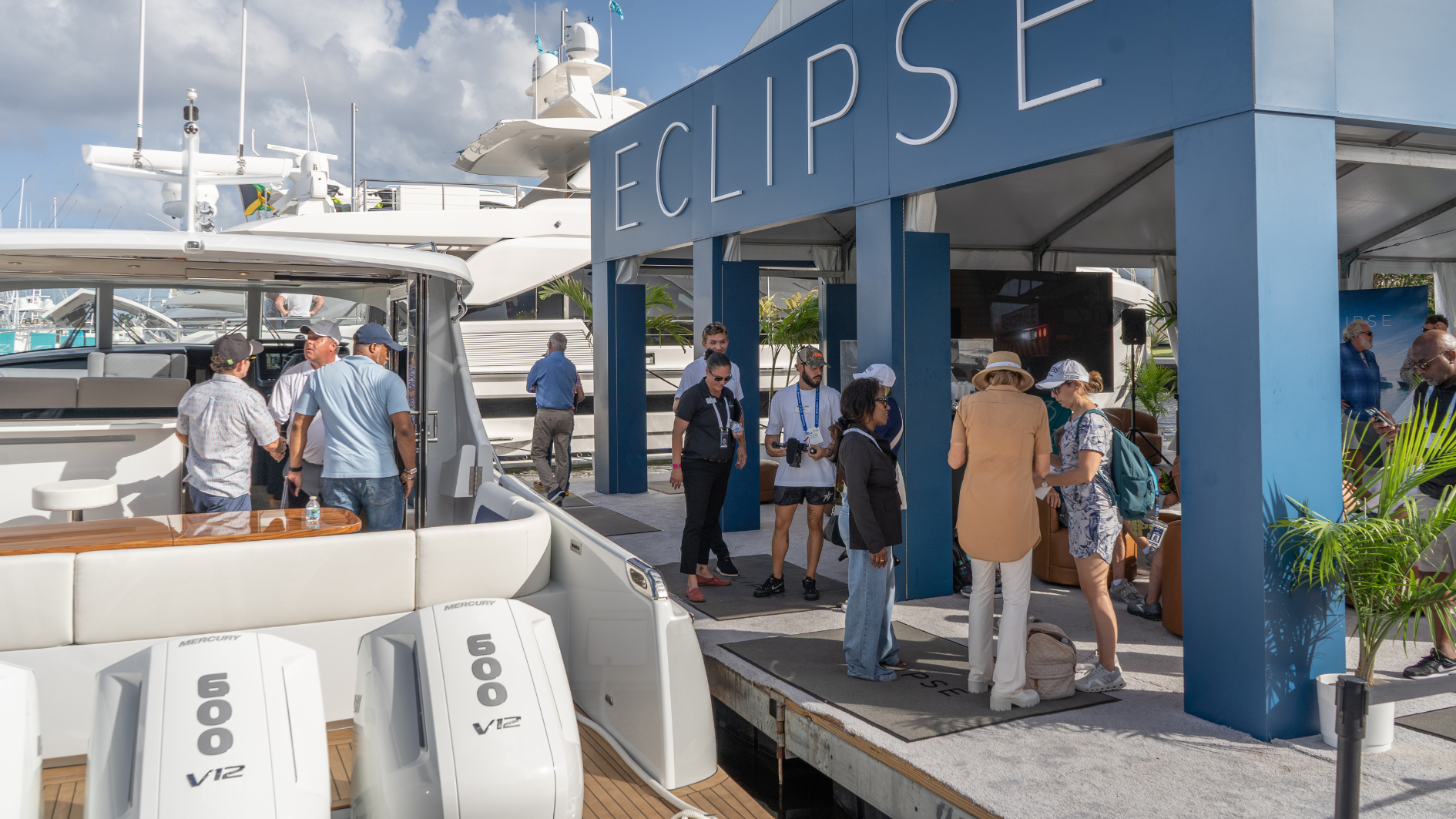 An ECLIPSE 505 Shadow in the water and on display at a boat show with customers on board.