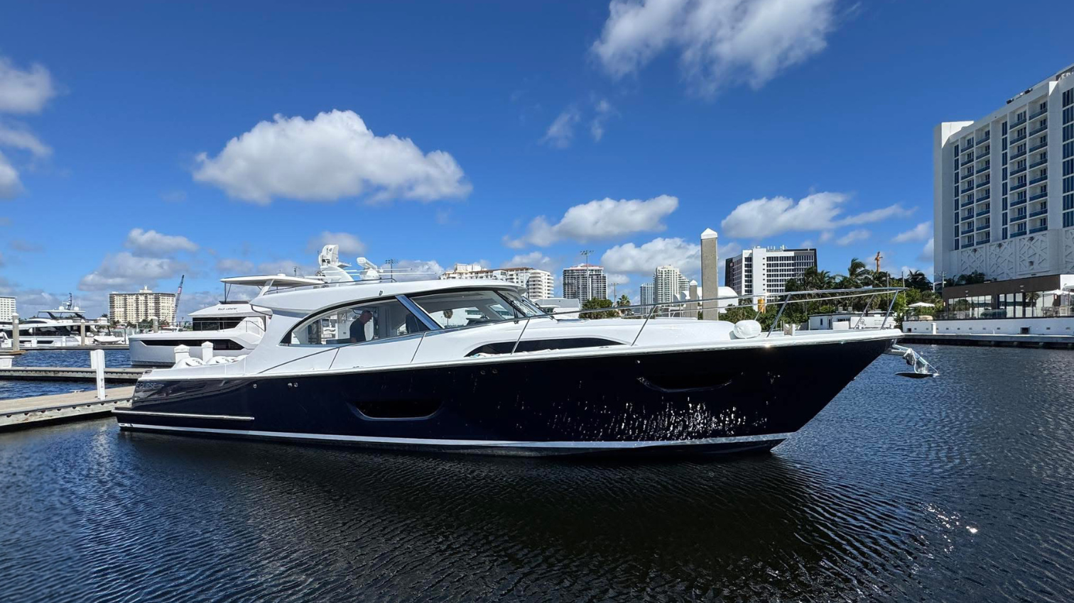 2026 ECLIPSE 505 Shadow with a Flag Blue Hull sitting in the water in a marina. 