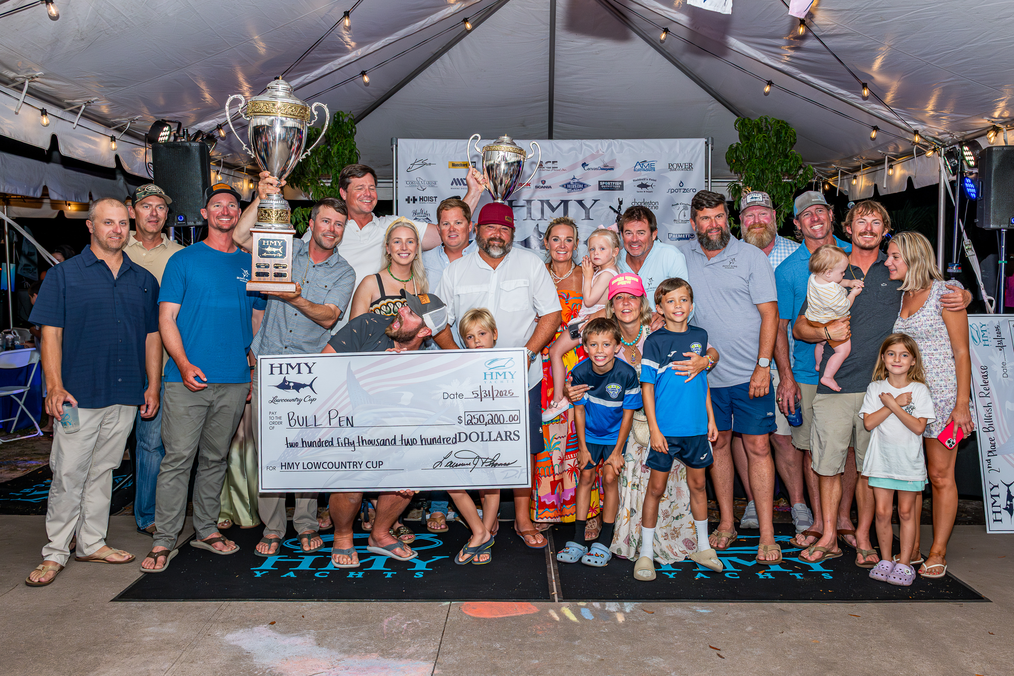 Photo of Low country cup award ceremony with the Bull Pen team posing with trophy and winning check