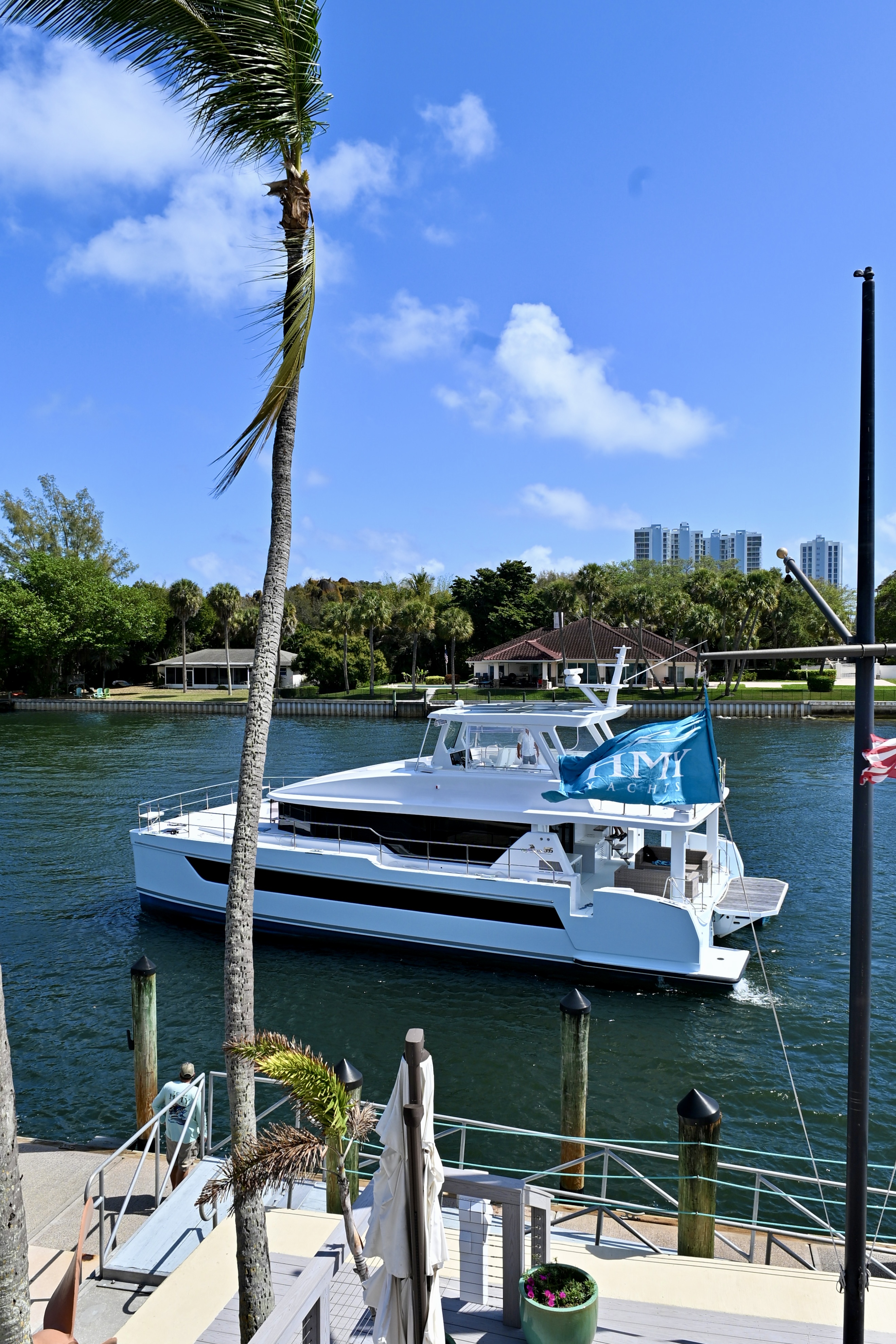 Vertical image of the 555 power catamaran sitting off of the dock in Palm Beach